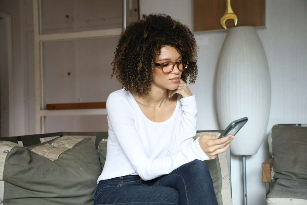 Woman sitting quietly on a bed in a reflective moment